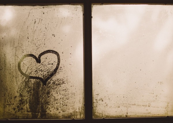 Heart drawn in the condensation on glass, caused by a similar dew point and temperature